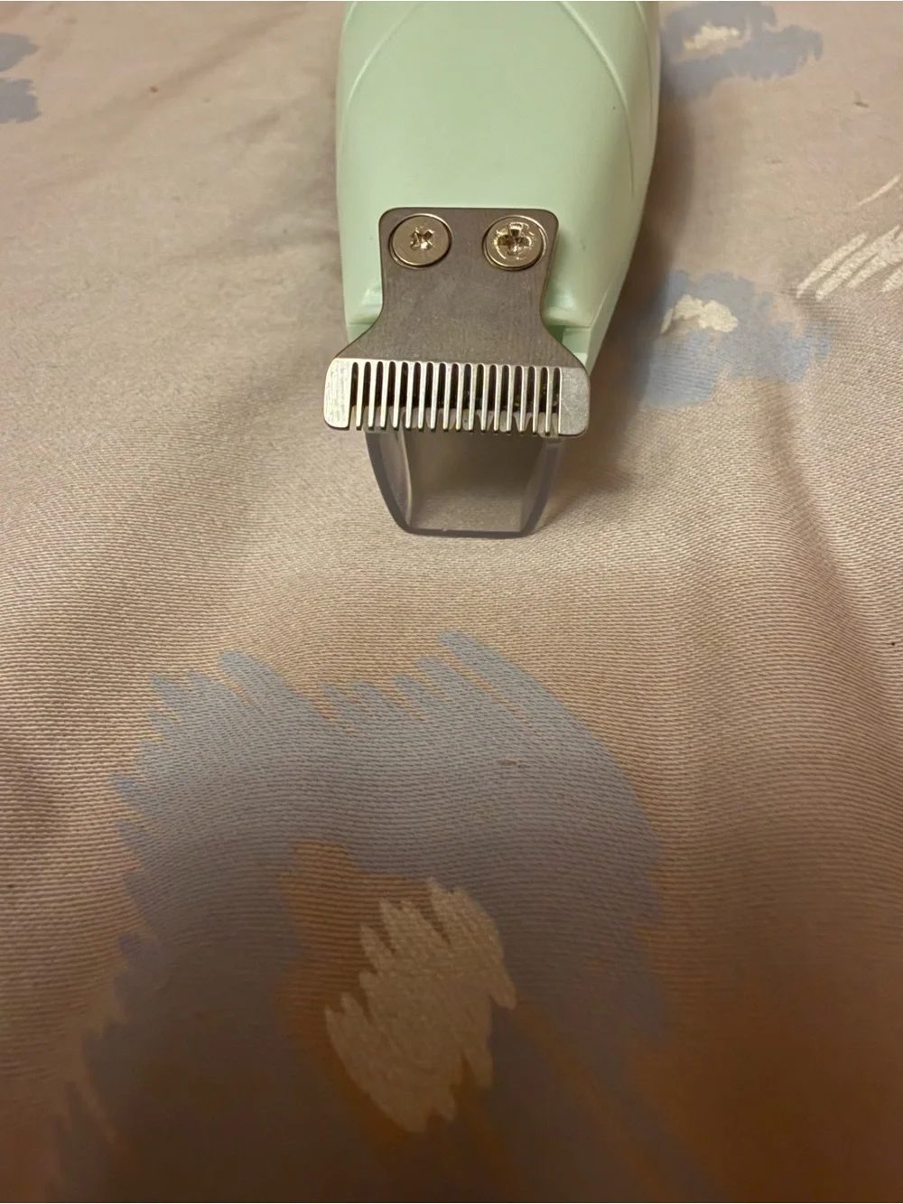This a green electric pet shaver designed for trimming hair on dogs and cats.